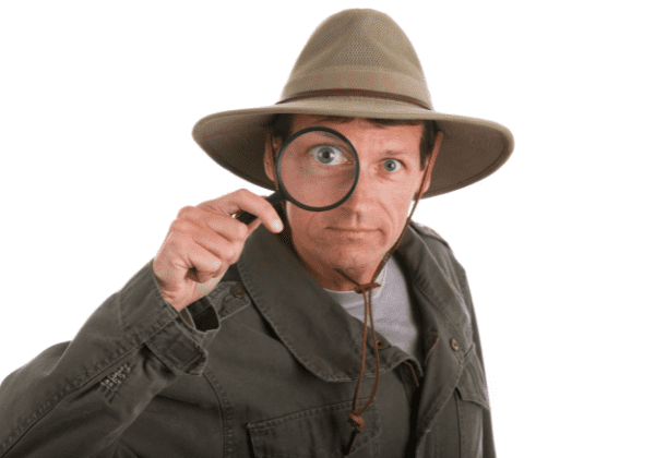 Man Looking Through A Magnifying Glass